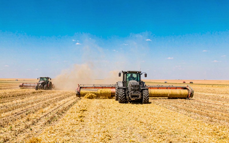 Red tractor working in green field with durable lawn and agriculture belts
